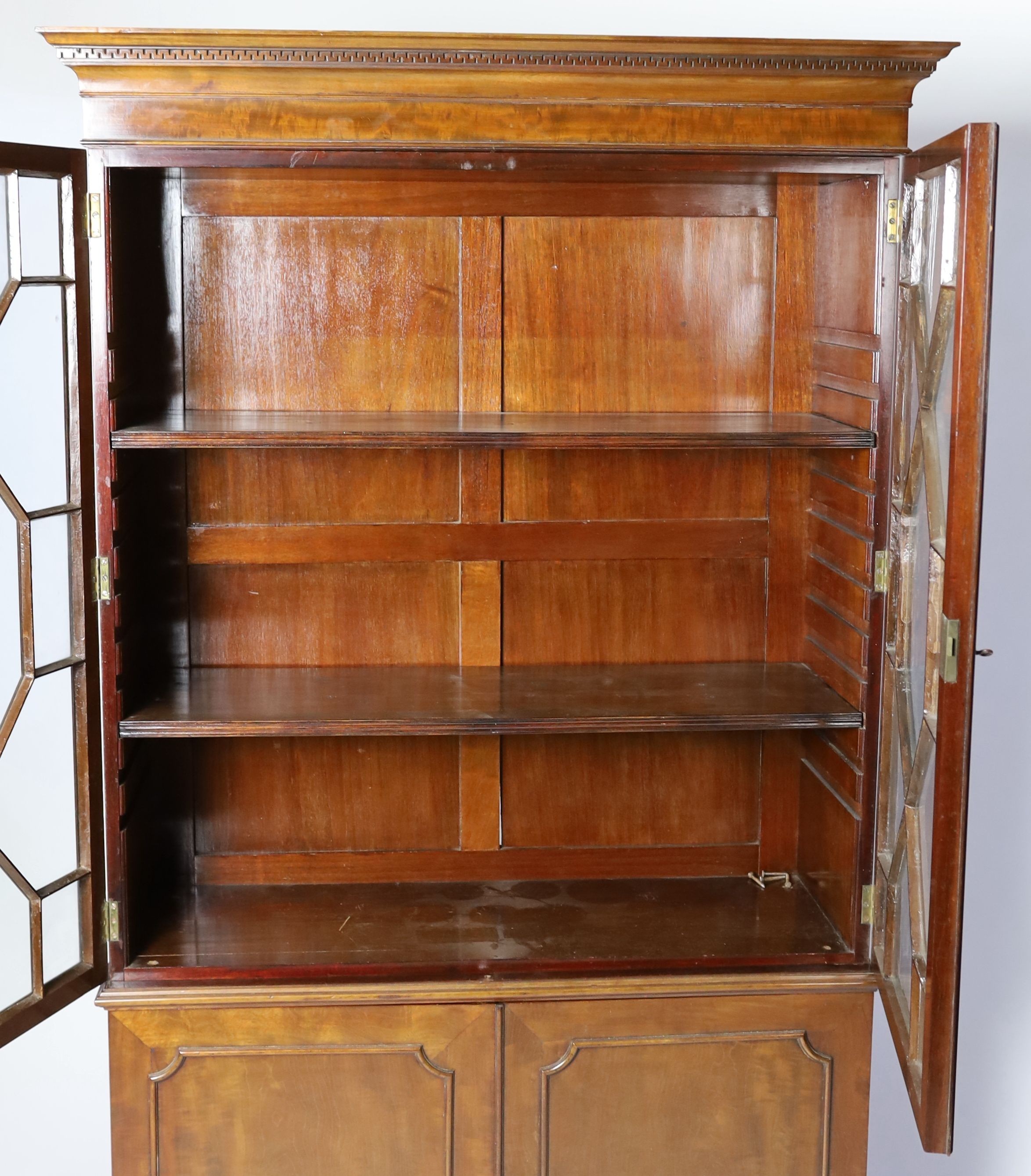 A reproduction George III style mahogany bookcase cupboard, width 106cm depth 37cm height 192cm